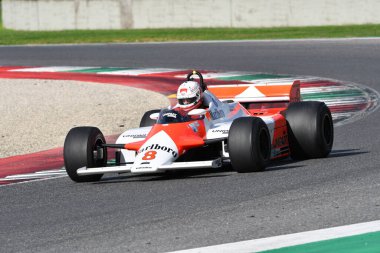 Scarperia, Italy - October 12th 2024: McLaren MP4/1B of year 1982 ex Niki Lauda drive by unknown in action during practice session at Mugello Circuit. clipart