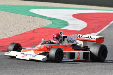 Scarperia, Italy - October 12th 2024: McLaren M23 of year 1976 ex Johen Mass and James Hunt drive by unknown in action during practice session at Mugello Circuit. clipart