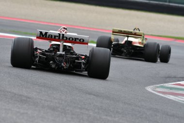 Scarperia, Italy - October 12th 2024: McLaren M23 of year 1976 ex Johen Mass and James Hunt drive by unknown in action during practice session at Mugello Circuit. clipart