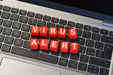 Laptop klavyesine 'VIRUS ALERT' yaz. Siber güvenlik kavramı.