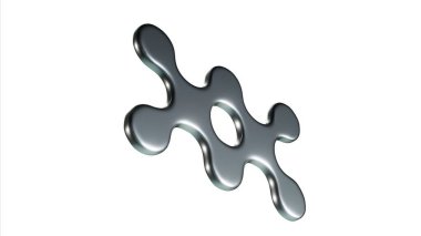 Ortasında delik olan gümüş bir nesne. Bu bir haç sembolü. Cisim parlak ve metalik.