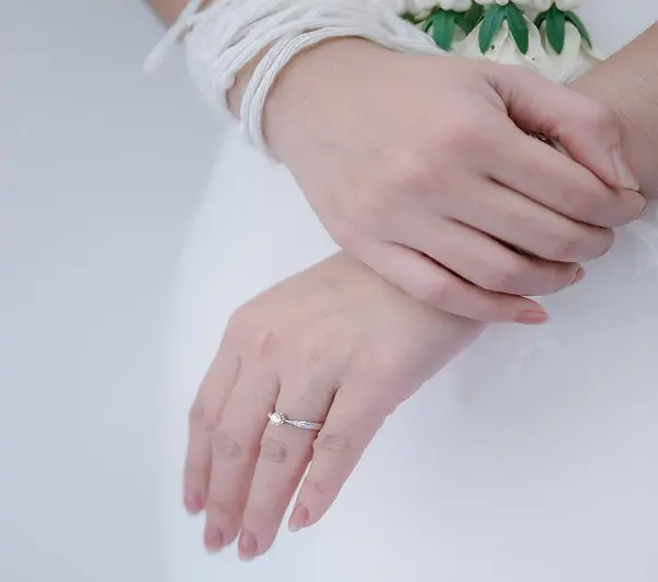 Symbol of having a partner on the ring finger of the left hand.