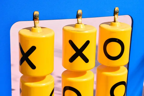 stock image Close-up yellow plastic educational alphabet x and o black letters called tic-tac-toe game or XO board game at playgroup outdoor.