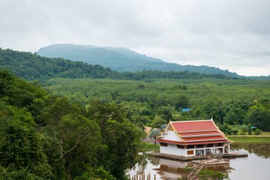 Bueng Kan, Tayland - 07 Eylül 2023: Puslarla kaplı güzel manzaralar ve gölün ortasında bir Tayland tapınağı bulunan ormanlar en iyi manzaralar ve turistler.