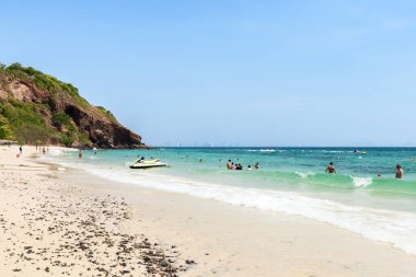 Pattaya, Thailand - March 7, 2024: Landscape of a Tropical beach and Blue sea on Koh Larn island. Group of Tourist or Traveler or many people on the beach. Vacation, Summer, Holiday, Nature, Relax. clipart