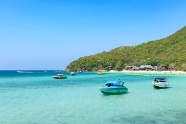 Pattaya, Tayland - 7 Mart 2024: Koh Larn adasında tropik bir sahil ve mavi denizin manzarası. Sahilde bir grup turist ya da gezgin. Tatil, Yaz, Tatil, Sürat teknesi, Gemi, Etkinlik.