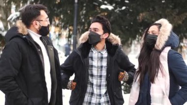 Group of Indian people wearing masks in public place. New generation students during the covid 19 pandemic. Walk and socialize in the city.