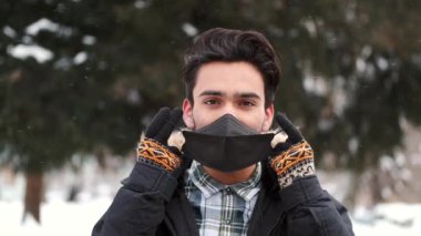 Close up head shot Young man wearing face mask. Pandemic coronavirus. COVID-19 Coronavirus Infection.