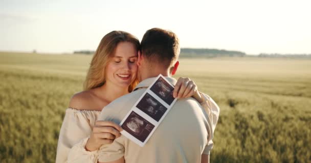 Pregnant Woman Husband Holding Ultrasound Baby Image Loving Man Hugging — Video