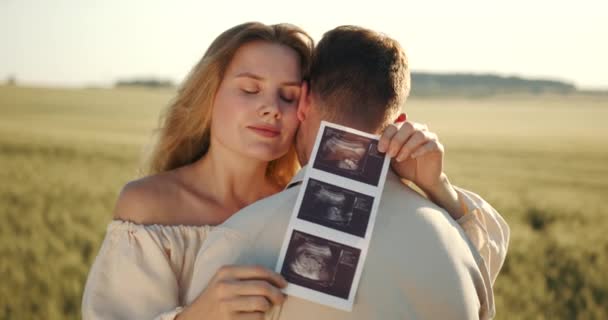 Pregnant Woman Husband Holding Ultrasound Baby Image Loving Man Hugging — Vídeo de stock