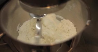 Profesyonel bir elektrikli mikserde hamur hazırlığı. Profesyonel hamur karıştırıcı. Modern aletler mutfakta.