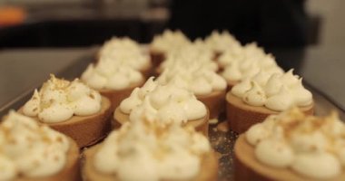Mini tart yapma süreci. Mini tartları rendelenmiş fındıklarla süsleyip serp..