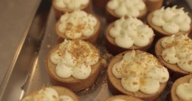 Mini tart yapma süreci. Mini tartları rendelenmiş fındıklarla süsleyip serp..