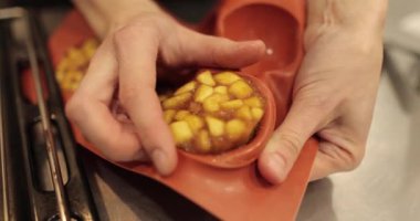 Elmalı kekler şurupla doludur, kadınların elleri silikon pişirme kağıdından bitmiş ürünleri çıkarır. Profesyonel yemek pişirme..