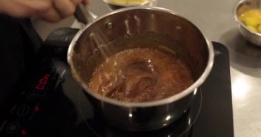 Tatlı yapmak için çikolatalı mousse 'a tereyağı ekleyip karıştırıyorum. Çikolata hazırlama, profesyonel mutfak, fırın, şekerleme