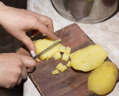 Tahtada patates dilimlemek.