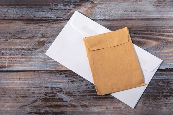 envelope and envelope on wooden background