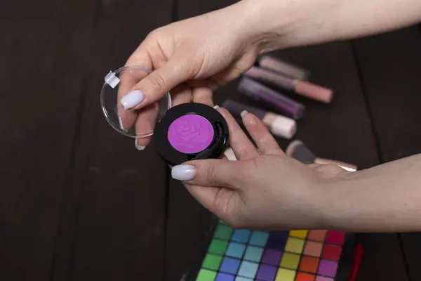 Makeup powder in the hands of a makeup artist.