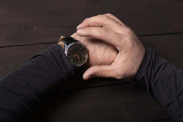 man pointing at hand watch