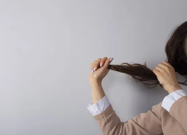 woman hand a hair.Hair damage, health and beauty concept.