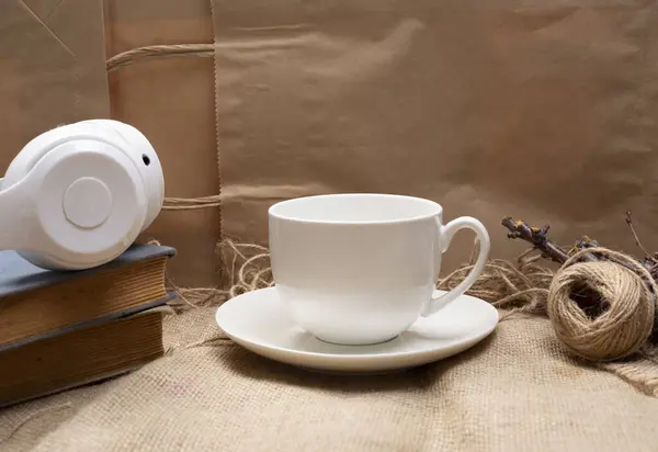cup of coffee and book headphone on wooden abckground