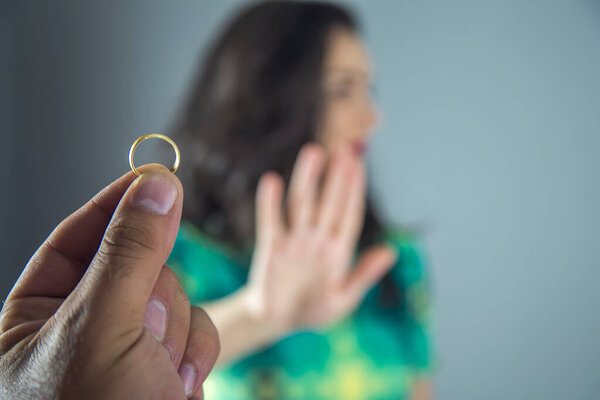 wedding ring on the hand of her husband 