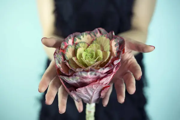 Woman holding a rose head in her hands