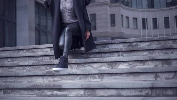 stylish  woman walking up stairs