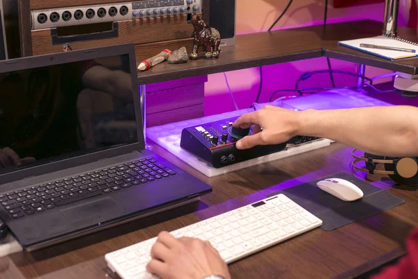 man working on computer in music studio