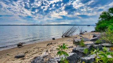 Grand Traverse Bay, Michigan shore on a partly cloudy day. View from the shore. clipart