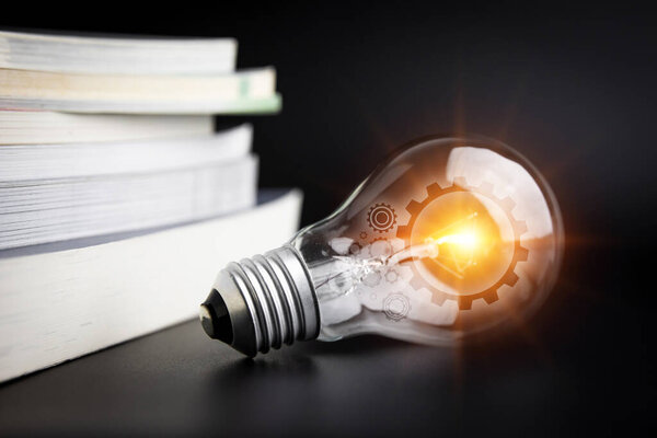 light bulb on the open book. education and creativity.