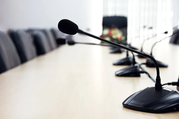 microphone on desk with conference background, empty conference hall