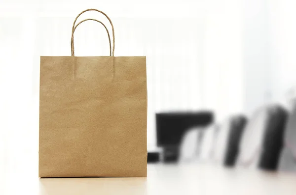 blank paper bag on white wooden background, copy space.