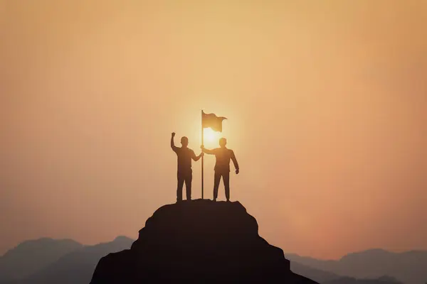 silhouette of a family of two people on the top of a hill. concept of family life, happy family, father and son with dog.