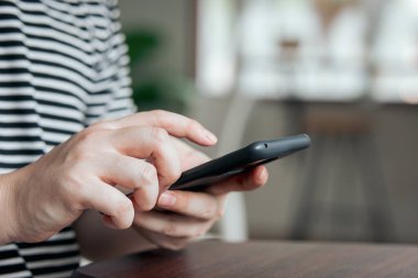 El, sosyal medyayı takip etmek ve çevrimiçi bilgi aramak için akıllı telefon uygulaması kullanıyor.