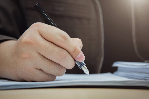 businessman writing in notebook