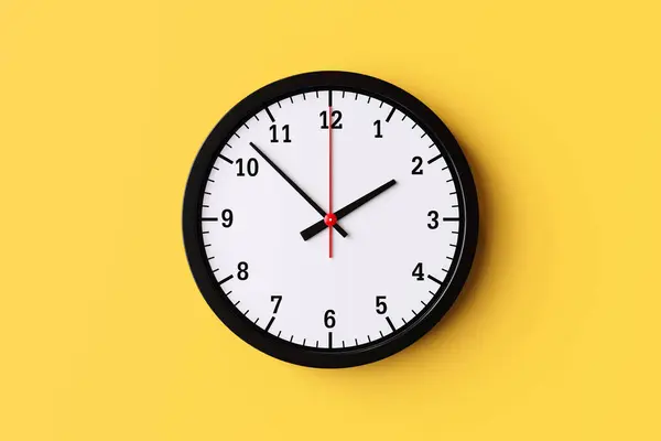 Circle clock with hour and minute hands on the background. Concept of management time, working hours and alarm clock notification. With copy space and business design