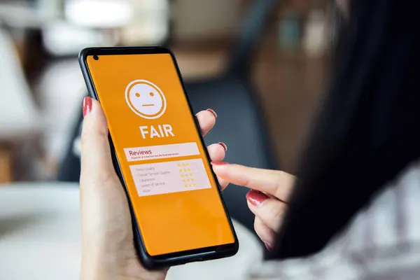Evaluating quality and service of restaurants. Customers using smartphones select a fair level, normal emojis. Concept of store development from recommend and evaluation