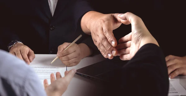 Business negotiations, joint venture agreements between two businesses, and employment contracts. Businessmen check qualifications for recruiting talent and shake hands after approval success.
