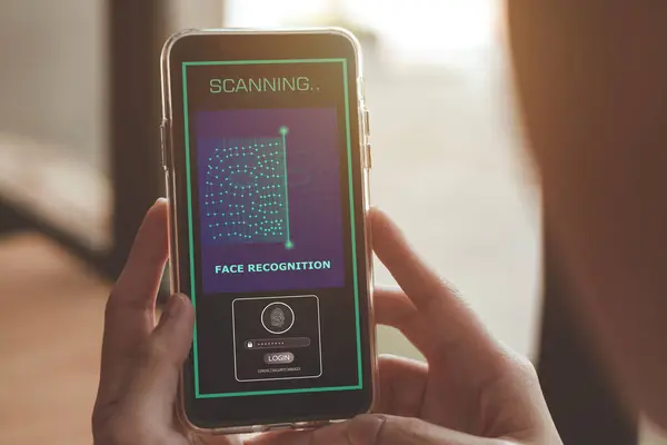 Security system with facial recognition, Face ID. Woman unlocks smartphone with biometric identification scan, personal verification