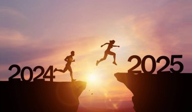 Yeni Yıl 2025, ilham ve yeni başarı yolunda ilerleme. Yeni yıl 2025 gün batımında insan siluetleri uçurumdan bitiş çizgisine doğru atlıyor.