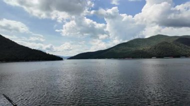 Bhumibol Dam, Thailand, beautiful scenery amidst the nature of river near large dam, with mountains and trees. Renewable hydropower plants for generating electricity reduce greenhouse gas emissions.