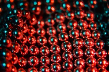 The beads sparkle in the reflection of the lights