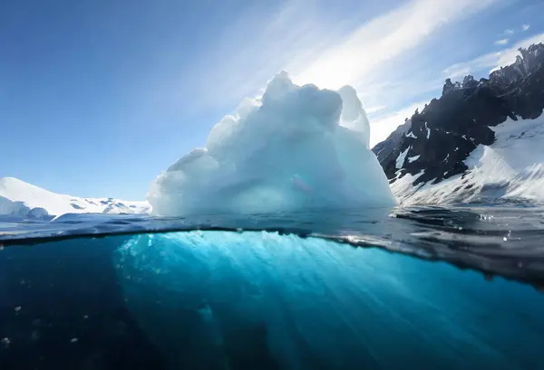 Iceberg in the ocean with blue sky and white clouds, Antarctica