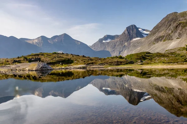 Mountains reflected in the water of a mountain lake. Norway.
