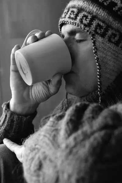 young man drinking coffee in winter morning , black and white photo