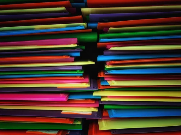 colored document folders on a colored black background