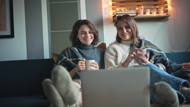 Two Cheerful Women Watching Movie Laptop While Sitting Sofa — Wideo stockowe