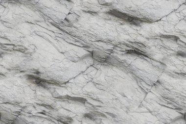 Açık ve koyu gri tonlarda karmaşık ve düzensiz desenler içeren doğal mermer yüzey. Doku, dinamik ve katmanlı bir tasarım yaratan çizgiler ve damarlarla pürüzsüz ama görsel olarak karmaşık görünüyor..