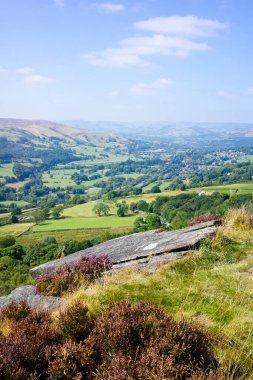 Scenic countryside landscape with lush green fields and rolling hills under a clear blue sky. Hathersage moor Derbyshire UK. clipart